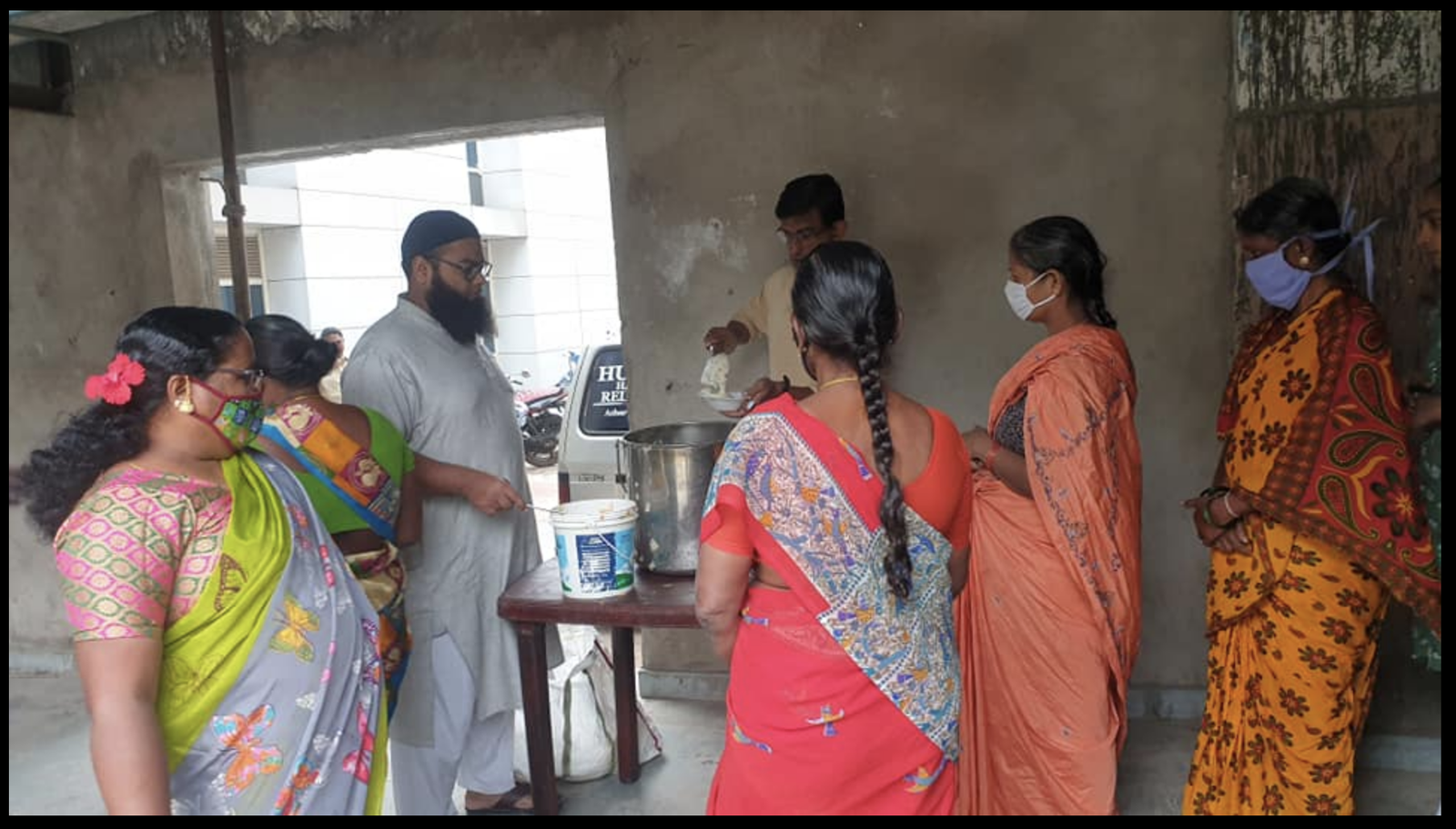 Volunteers serving meals at the new distribution venue
