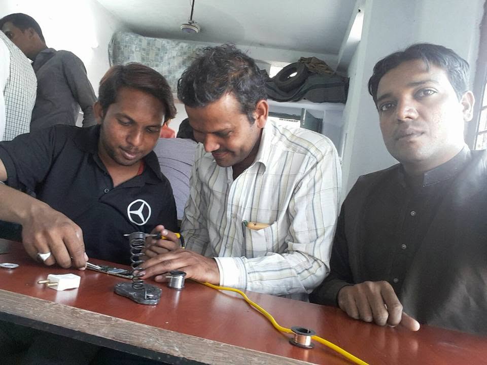 Students learning mobile phone repair skills