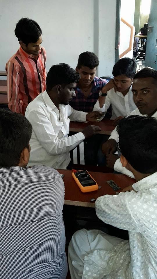 Students gaining practical mobile repair experience